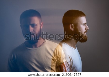 Double exposure crative side view profile and portrait of artistic bearded model man in white t-shirt looking at camera with calm serious face. special blurred beauty effect. indoor studio shot.