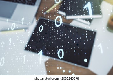 Double exposure of creative abstract binary code hologram and digital tablet on background, top view. Database and programming concept