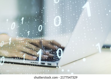 Double exposure of creative abstract binary code hologram and hands typing on laptop on background. Database and programming concept