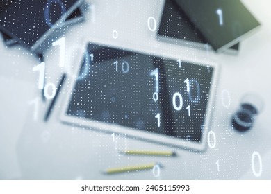 Double exposure of creative abstract binary code hologram and digital tablet on background, top view. Database and programming concept