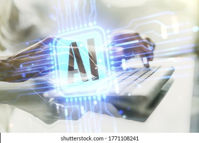 Double exposure of creative artificial Intelligence icon with hands typing on laptop on background. Neural networks and machine learning concept