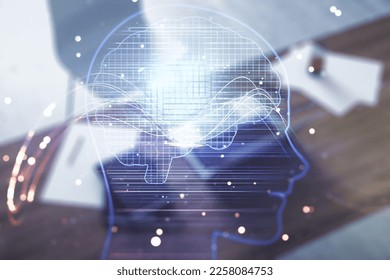 Double exposure of creative artificial Intelligence symbol and modern desktop with laptop on background. Neural networks and machine learning concept
