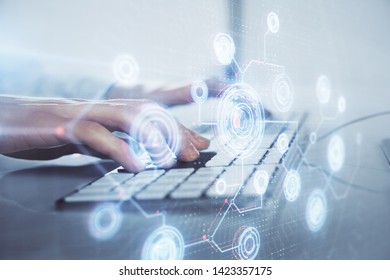 Double exposure of data internet theme hologram with man working on computer on background. Concept of innovation.
