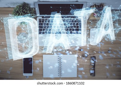 Double exposure of data theme drawing hologram over topview work table background with computer. Concept of technology.