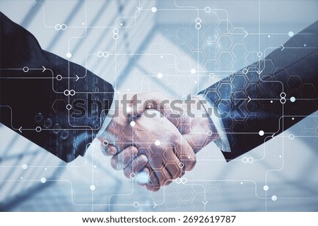 Double exposure of data theme hologram and handshake of two men. Partnership in IT industry concept.