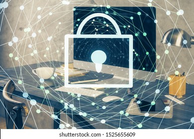 Double exposure of desktop with computer and lock icon hologram. Concept of data safety.