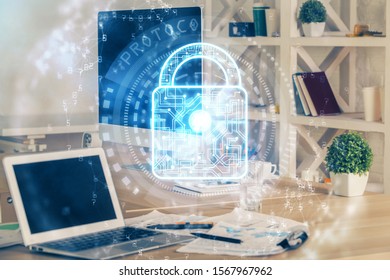 Double exposure of desktop with computer and lock icon hologram. Concept of data safety.
