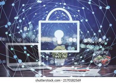 Double exposure of desktop with computer and lock icon hologram. Concept of data safety.