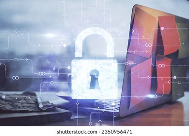 Double exposure of desktop with computer and lock icon hologram. Concept of data safety.
