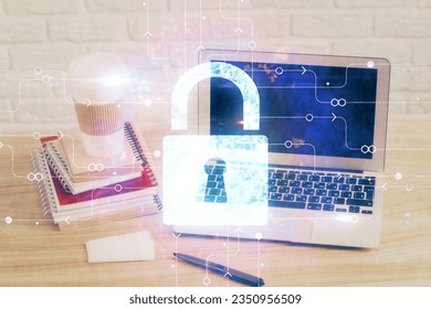 Double exposure of desktop with computer and lock icon hologram. Concept of data safety.