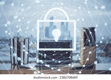 Double exposure of desktop with computer and lock icon hologram. Concept of data safety.