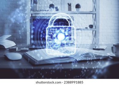 Double exposure of desktop with computer and lock icon hologram. Concept of data safety.