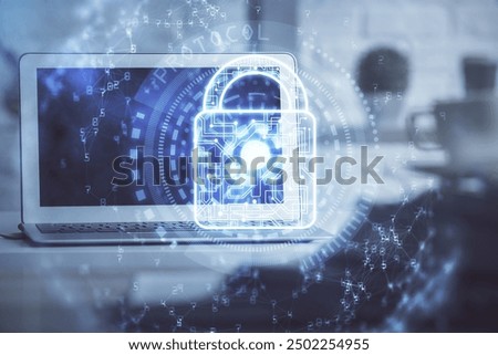 Double exposure of desktop with computer and lock icon hologram. Concept of data safety.