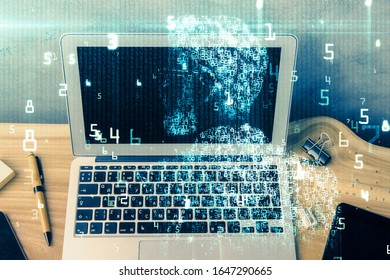 Double exposure of desktop computer and technology theme hologram. Concept of software development.