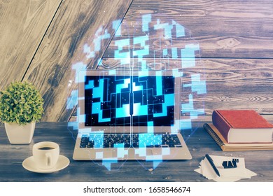Double exposure of desktop computer and technology theme hologram. Concept of software development.
