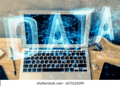 Double exposure of desktop computer and technology theme hologram. Concept of software development.