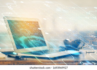 Double exposure of desktop computer and technology theme hologram. Concept of software development.