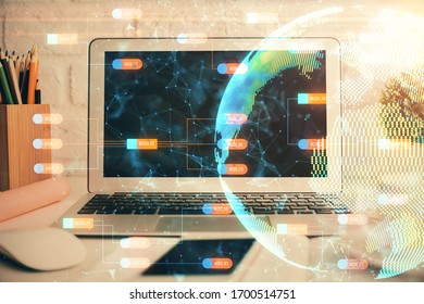 Double exposure of desktop with computer and world map hologram. International data network concept.