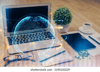 Double exposure of desktop with computer and world map hologram. International data network concept.