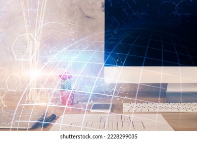 Double exposure of desktop with computer and world map hologram. International data network concept.