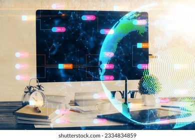 Double exposure of desktop with computer and world map hologram. International data network concept.