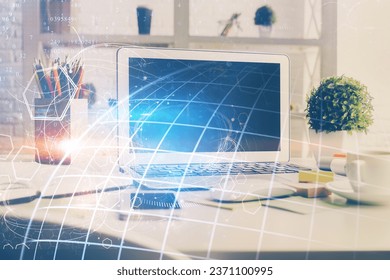 Double exposure of desktop with computer and world map hologram. International data network concept.