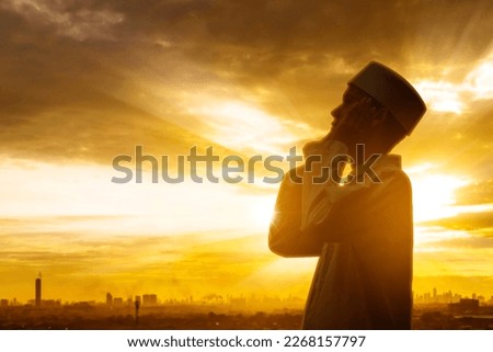 Double exposure of devout man doing azan while standing with city background