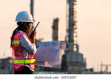 Double exposure of Engineer with safety helmet in front of Oil refinery and gas industry - refinery at sunset background, Business Insustrail concept