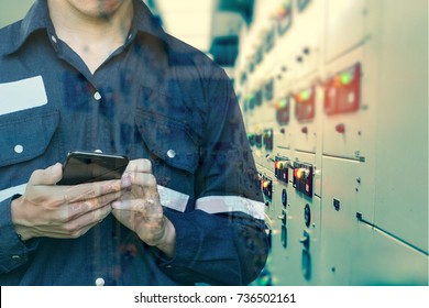 Double Exposure Of  Engineer Or Technician Man Using Smart Phone For Control Electric In Switch Gear Electrical Room Of Oil And Gas Platform Or Plant Industrial For Business And Industry 4.0 Concept.