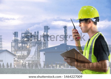 The double exposure of the engineer using walky talky with oil refinery plant. Energy and industrial concepts