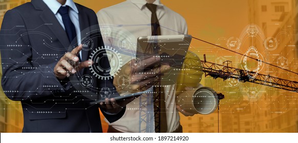 Double exposure of engineering  hand touching on network connection interfaces icon with construction cranes blurred background.