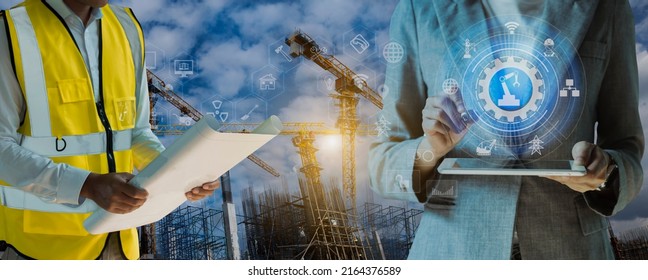 Double exposure engineering team using tablet computer and digital technology interfaces icon on construction cranes background, Technology and business industrial concept.