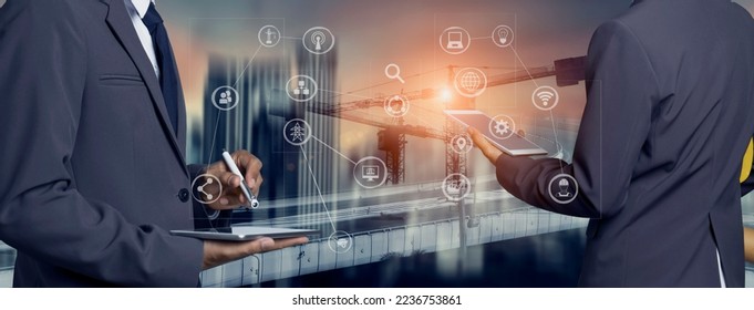 Double exposure engineering team using tablet computer and digital technology interfaces icon on construction cranes background, Technology and business industrial concept.