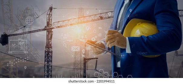 Double exposure engineering working with digital technology interfaces icon and construction cranes on city background, Smart industry and digital technology and IOT software concept.