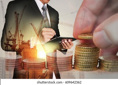 Double exposure of Euro Coin stacks on table, businessman working with tablet, construction crane, building and sunset as business, investment,currency, exchange rate, technology and industry concept. - Powered by Shutterstock