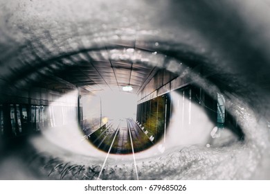 Double Exposure Of The Female Eye And Tunnel With Train Car In Subway