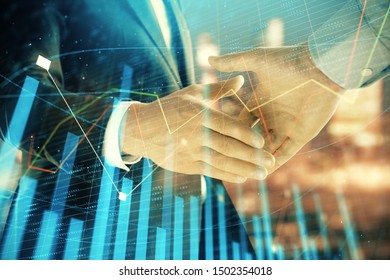 Double exposure of financial chart on cityscape background with two businessmen handshake. Concept of financial analysis and investment opportunities - Powered by Shutterstock