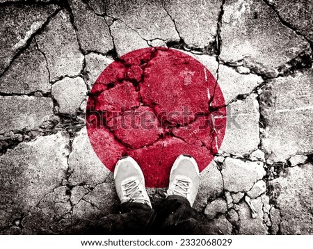 Double exposure of the flag of Japan with cracks in the gravel. A symbol of disintegration or division is depicted. Steps toward collapse. Useful for basemaps or report descriptions