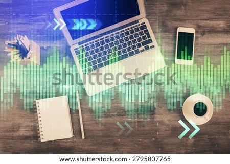 Double exposure of forex chart drawing over table background with computer. Concept of financial research and analysis. Top view.