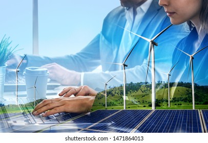 Double Exposure Graphic Of Business People Working Over Wind Turbine Farm And Green Renewable Energy Worker Interface. Concept Of Sustainability Development By Alternative Energy.