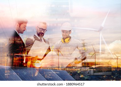 Double Exposure Graphic Of Business People Working Over Wind Turbine Farm And Green Renewable Energy Worker Interface. Concept Of Sustainability Development By Alternative Energy.