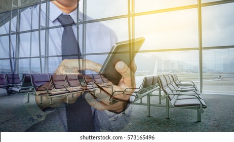 Double exposure of hand hold and touch screen smart phone with airport blurry background.  - Shutterstock ID 573165496