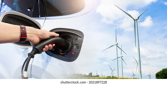 Double Exposure Of Hand Man Holding Electric Car Charging In Power Station.