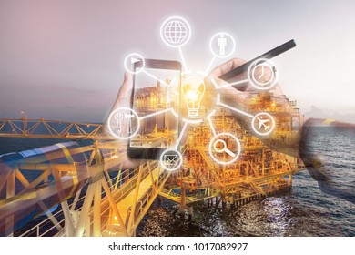 Double Exposure Of Hand Using Smart Phone With Digital Icon For Industry 4.0 Concept With Offshore Oil And Gas Platform Background For Industrial Business Concept.