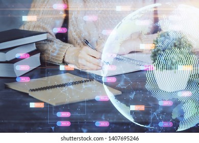 Double exposure of hands making notes with world map hologram and data theme icons. Concept of global computer data.