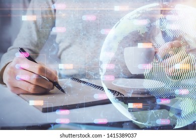 Double exposure of hands making notes with world map hologram and data theme icons. Concept of global computer data.