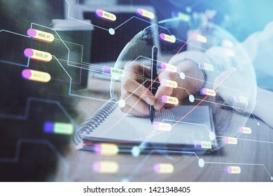 Double exposure of hands making notes with world map hologram and data theme icons. Concept of global computer data.