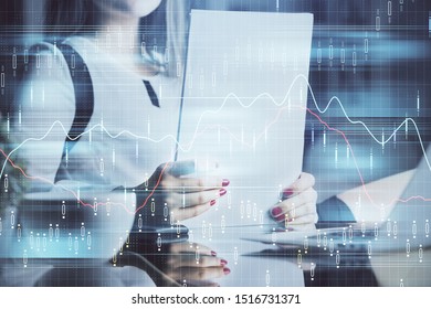 Double exposure of hands making notes with forex chart huds. Stock market concept.