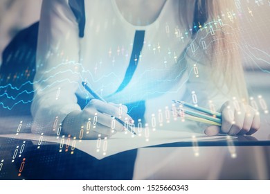 Double exposure of hands making notes with forex chart huds. Stock market concept. - Shutterstock ID 1525660343