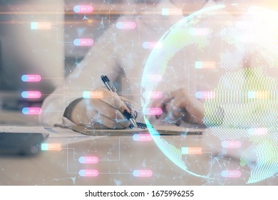 Double exposure of hands making notes with world map hologram and data theme icons. Concept of international network data.